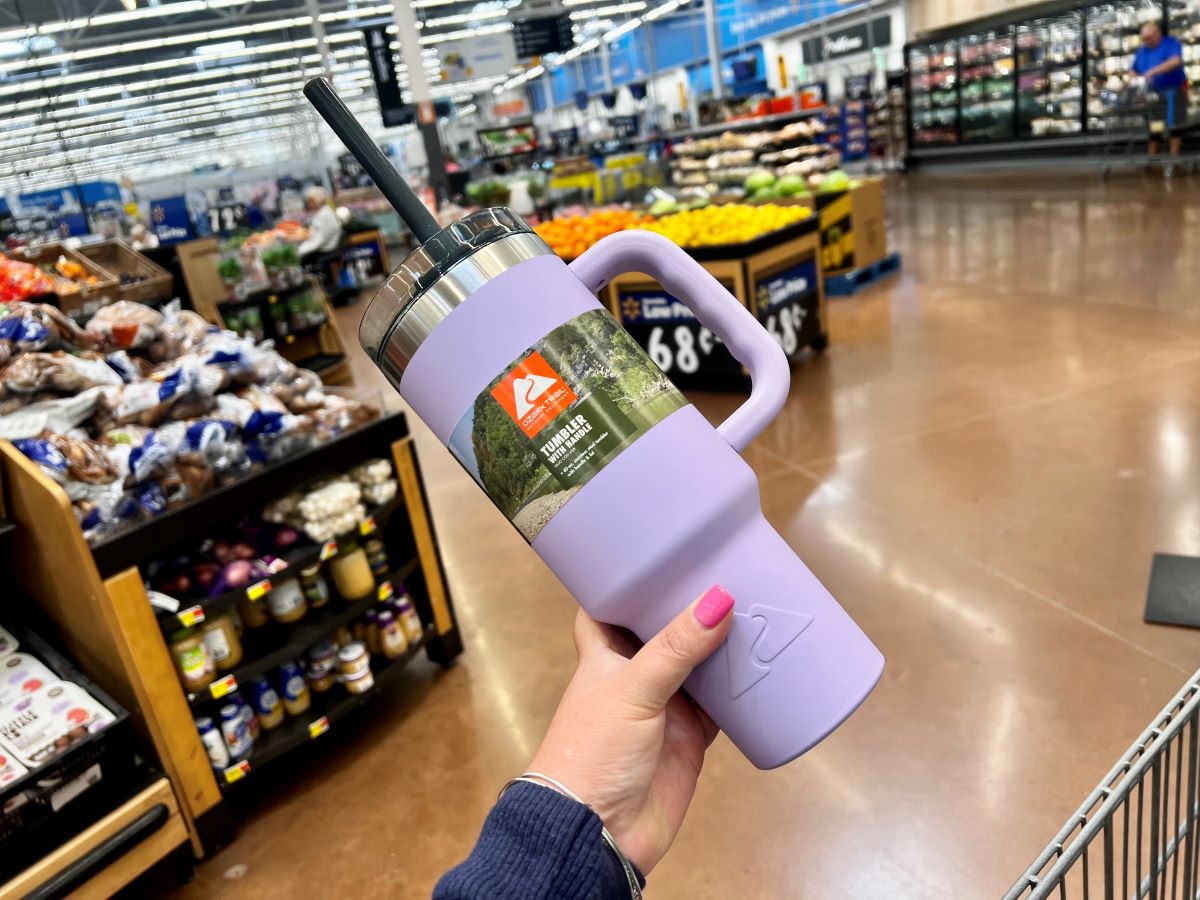 Hand holding a purple Ozark Trail tumbler