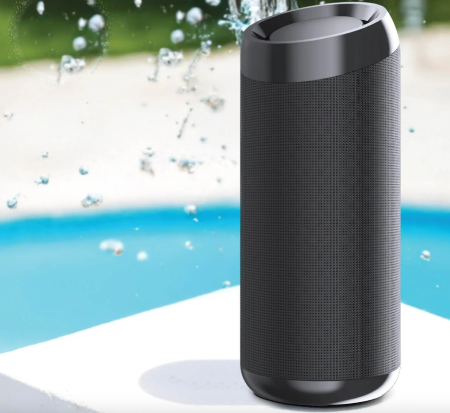 black portable speaker near water