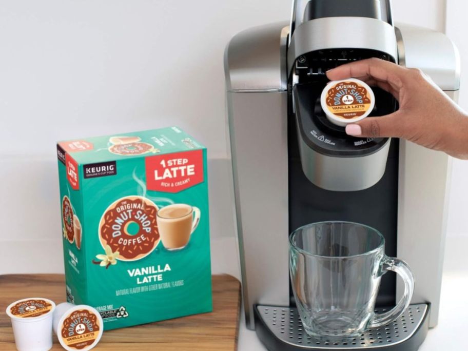 A Keurig Brewer with a box of Donut Shop Vanilla Latte K-Cups next to it