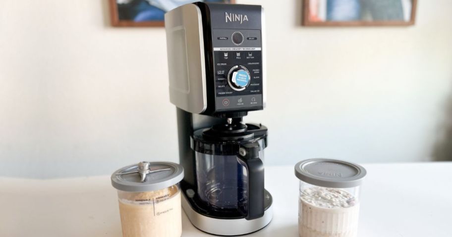 Ninja Creami Deluxe Machine next to two full pints of ice cream