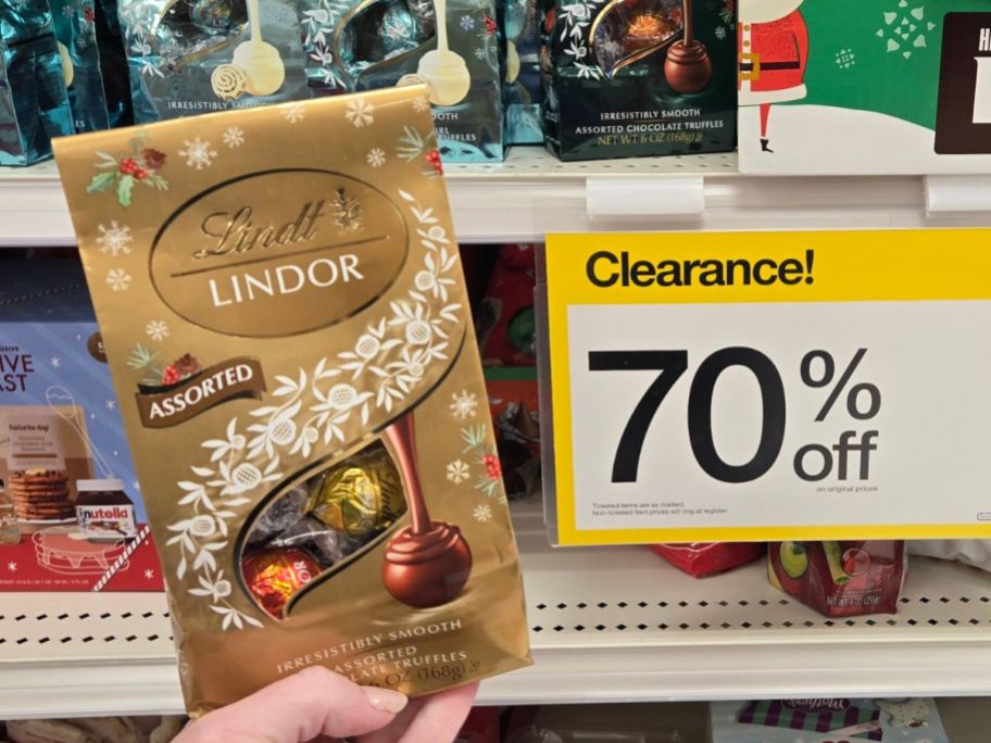 womans hand holding a bag of assorted chocolate truffles