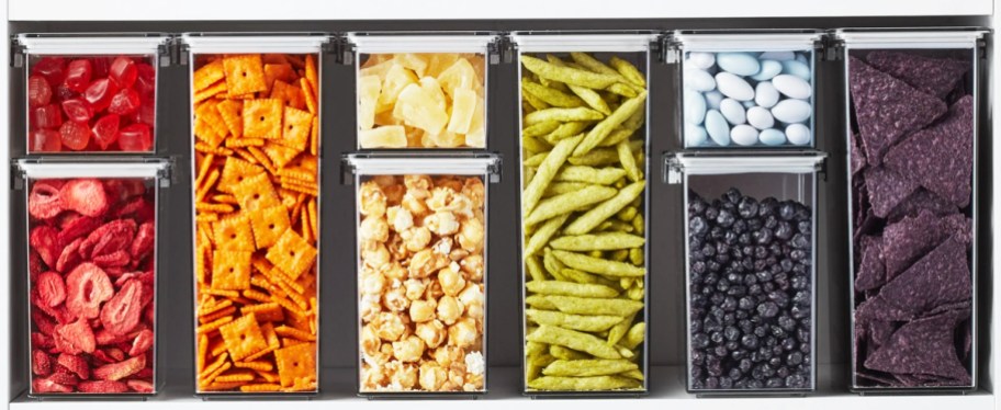 rainbow of snack foods stored in clear food storage containers