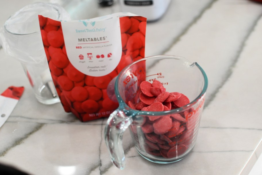 red candy melts in a glass container