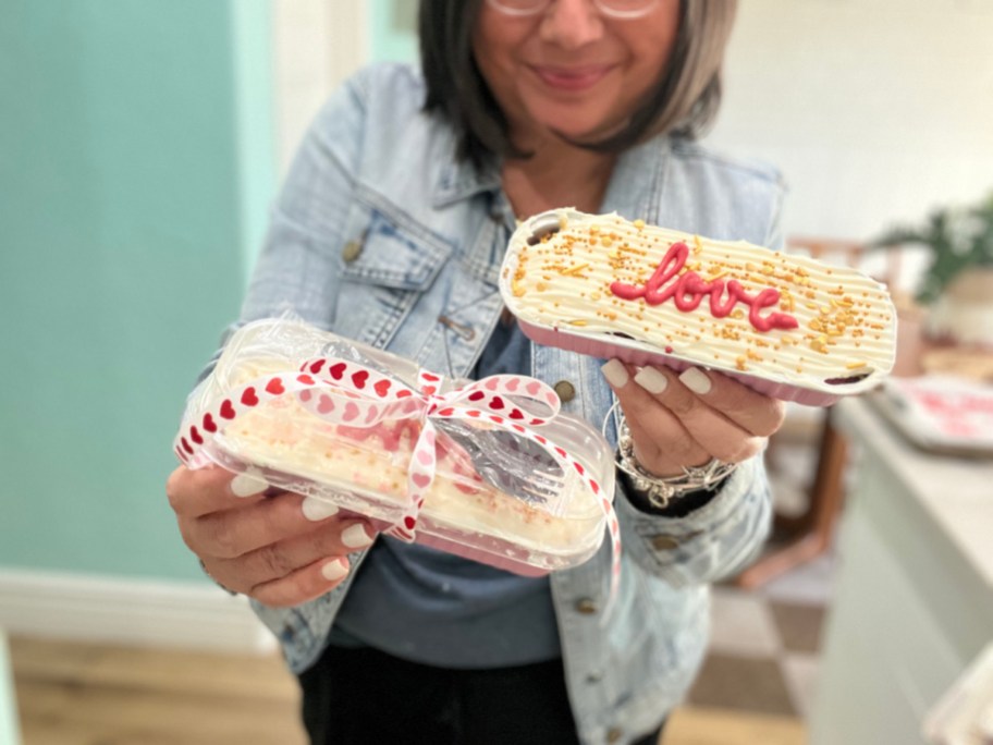 woman holding valentine's day cake tin gifts