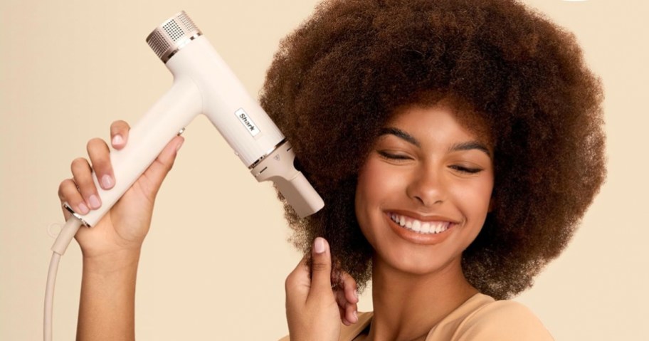 woman using white shark speedstyle hair dryer