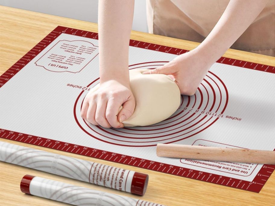 A woman kneading dough on a Silicone Baking Mat with Measurements