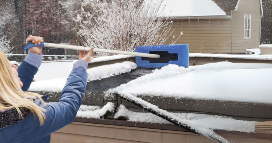 woman using Snow Joe The Original 2-in-1 Telescoping Snow Broom & Ice Scraper on car roof