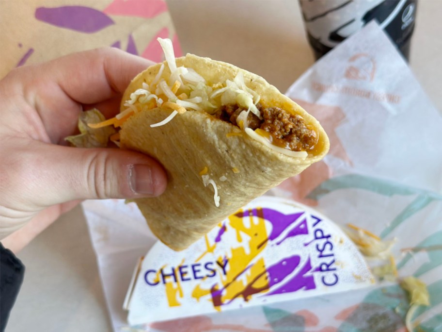 hand holding crispy taco at taco bell