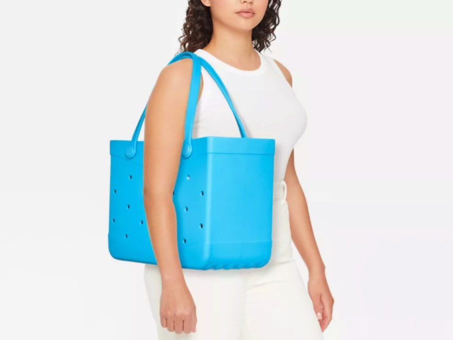 blue Shade & Shore Tote on a woman's shoulder