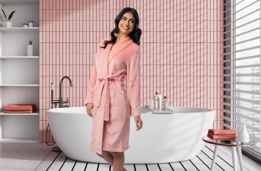 woman wearing pink fleece robe in pink bathroom