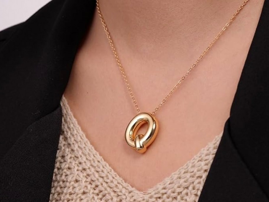 woman wearing gold q bubble necklace 