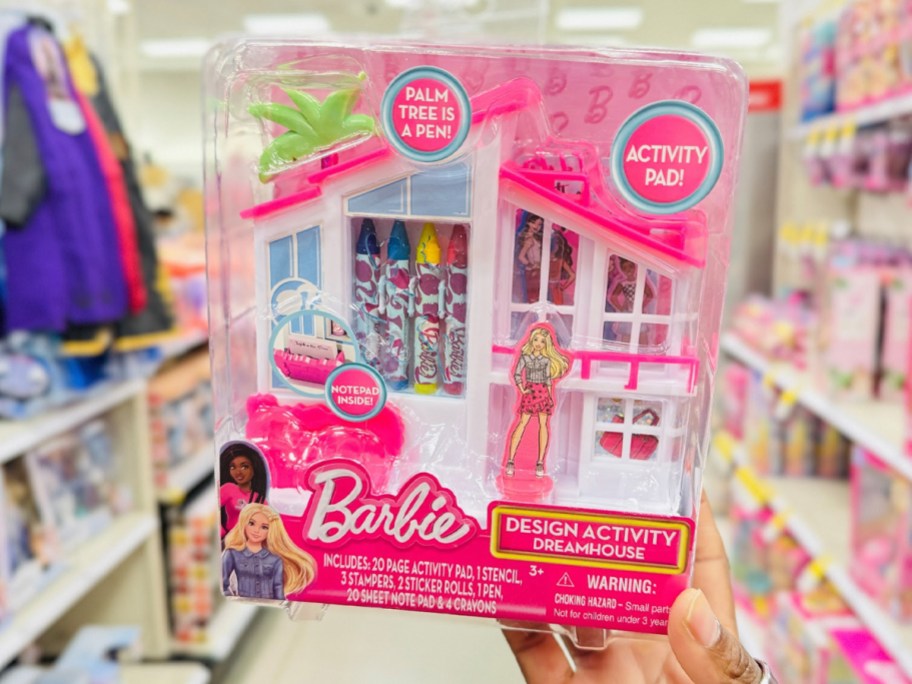 hand holding barbie dreamhouse set