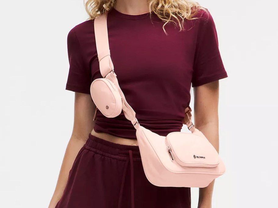 woman in a maroon outfit with a pink crossbody bag