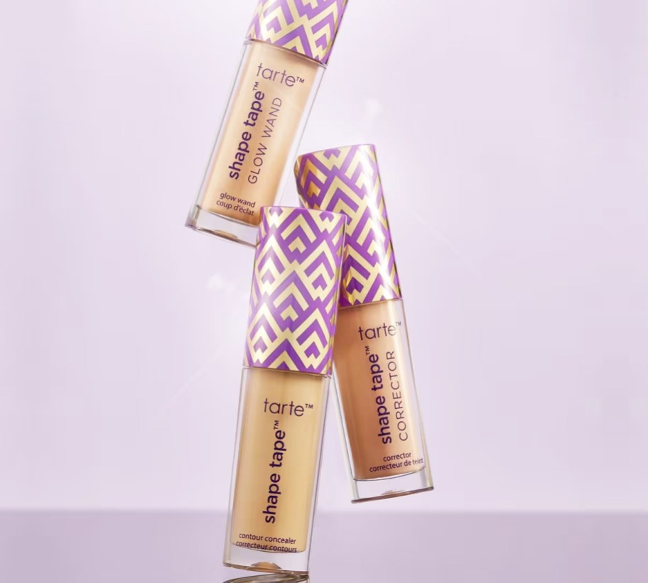 three mini tubes of Tarte Shape Tape on purple background