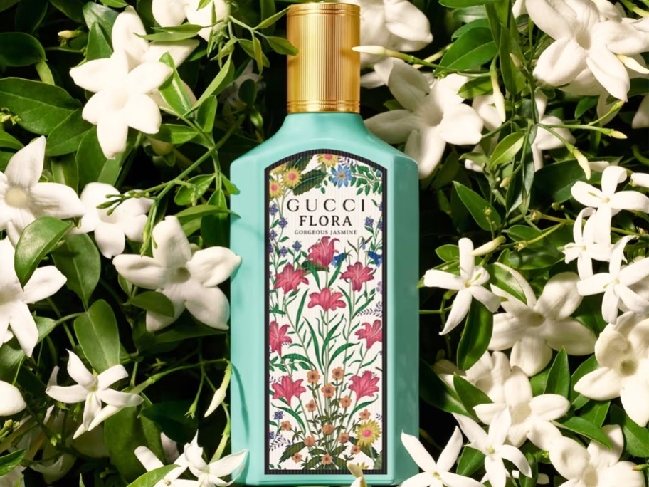 bottle of Gucci Flora Gorgeous Jasmine in jasmine flowers