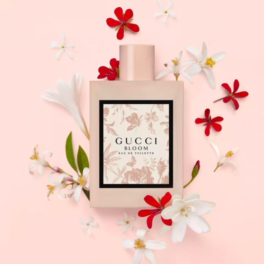 gucci bloom edt bottle surrounded by flowers