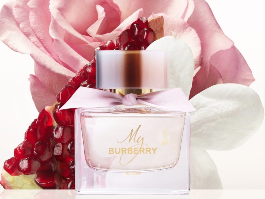 pink bottle of My Burberry Blush in front of flowers and pomegranate 