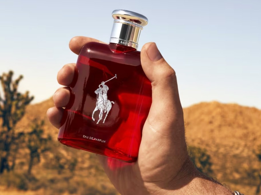 hand holding up a bottle of Ralph Lauren Polo Red