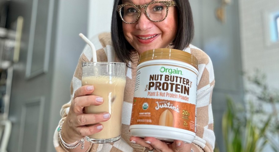 woman holding orgain nut butter jar and cup