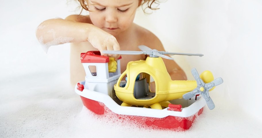 child in bathtub playing with Green Toys Rescue Boat with Helicopter