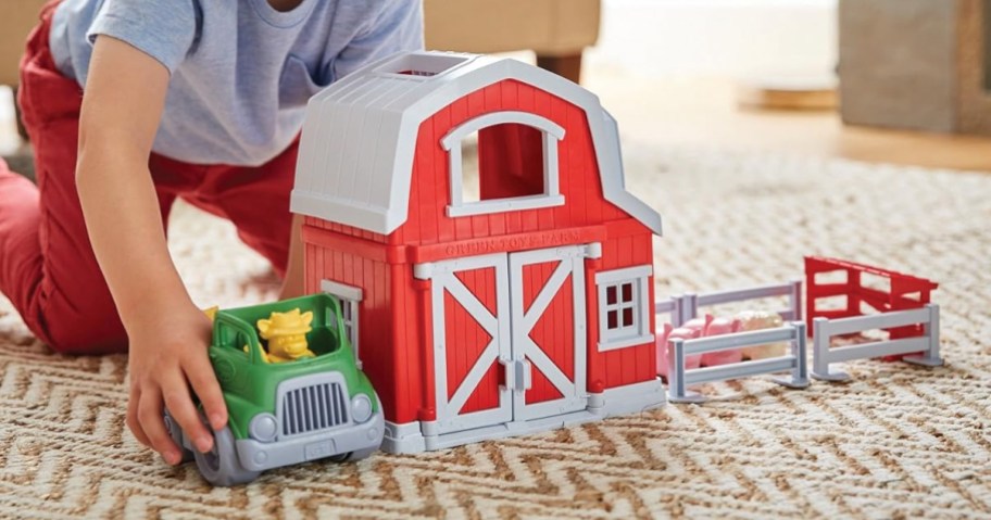 child playing with Green Toys Farm Playset