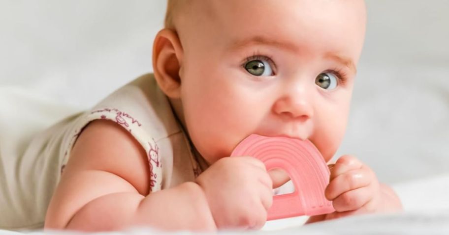 A baby holding a teething toy