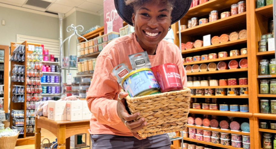 Woman holding yankee candle basket filled with deals