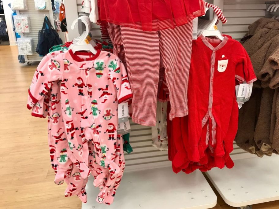 kids christmas pajamas hanging on a rack in a store