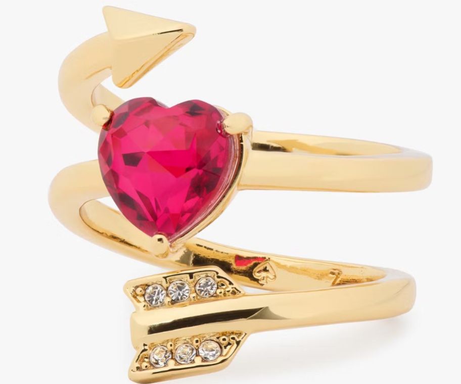 a gold ring with red heart stone and arrow