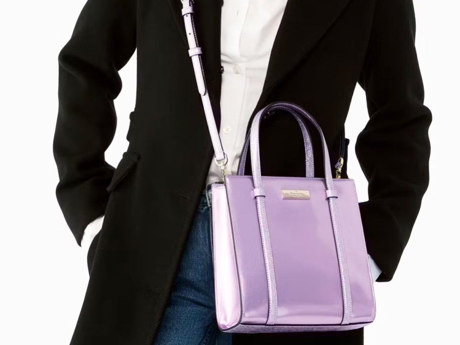 woman in a black jacket with a purple crossbody bag