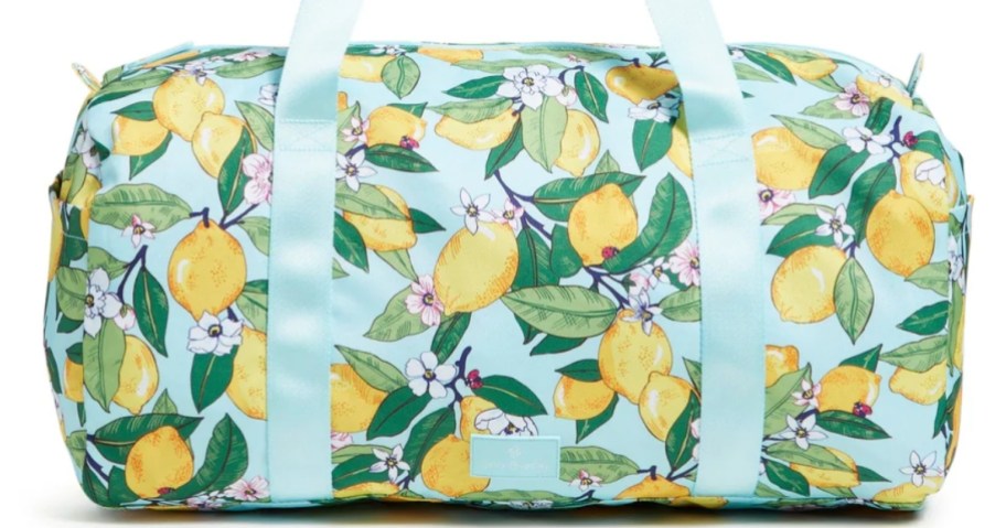 a large duffel bag in light blue with lemons print design