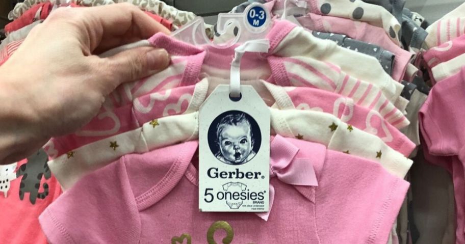 A Hanger with 5 Gerrber onesies on it