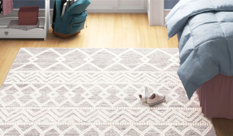 geometric print rug next to bed