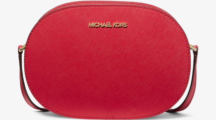 a medium red oval shaped crossbody handbag with a leather strap