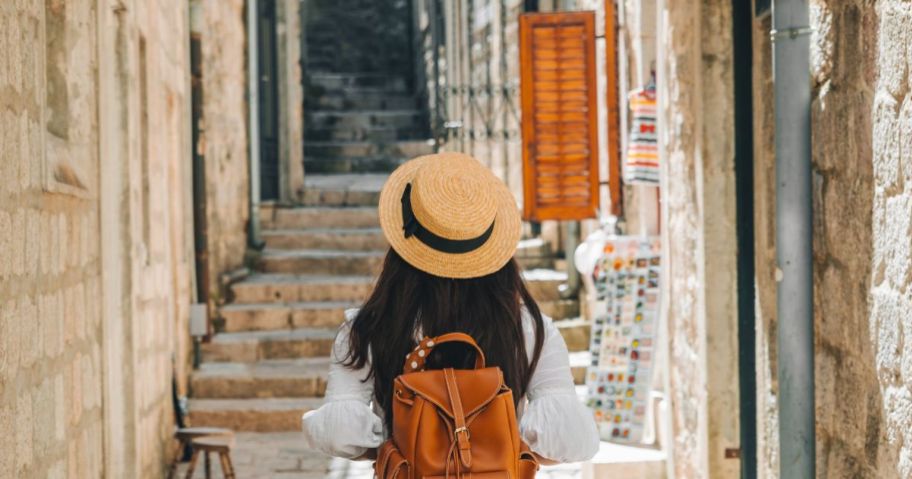 girl on vacation walking through city