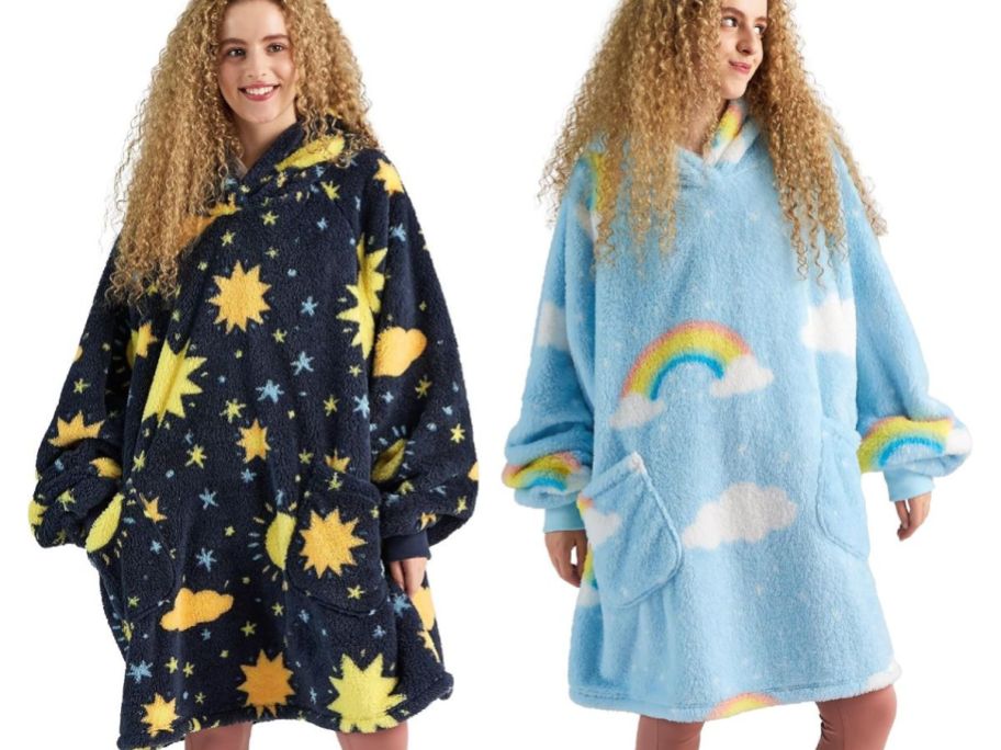 woman wearing galaxy wearable blanket hoodie and woman wearing cloud rainbow blanket hoodie