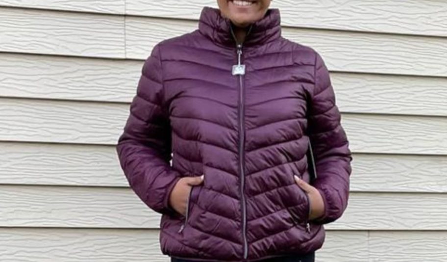 a woman wearing a burgundy puffer jacket