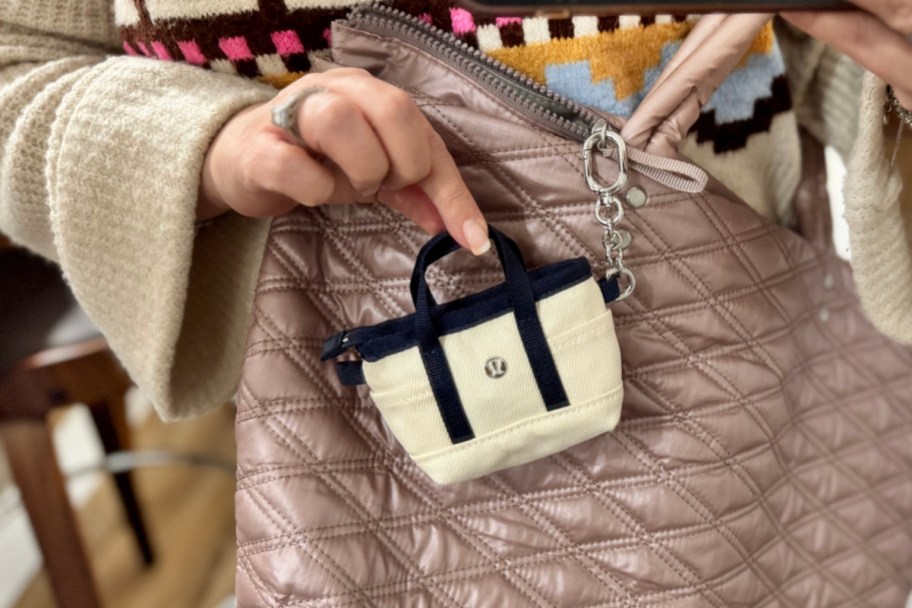 hand holding mini tote on purse