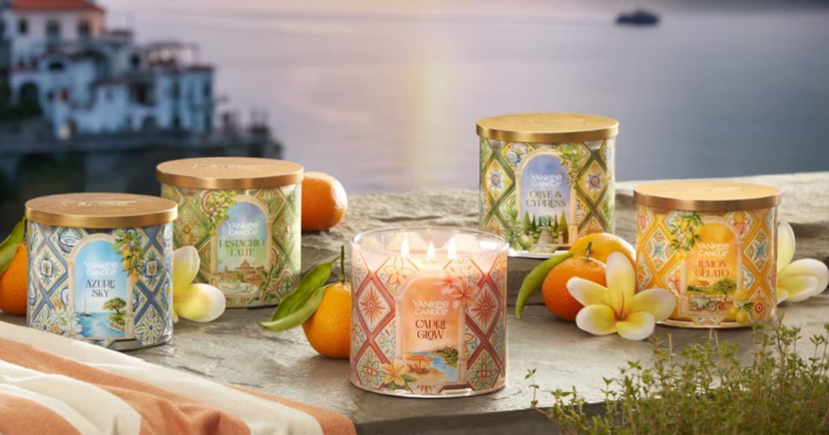 Yankee Candle 3-Wick Candles surrounded by oranges and flowers