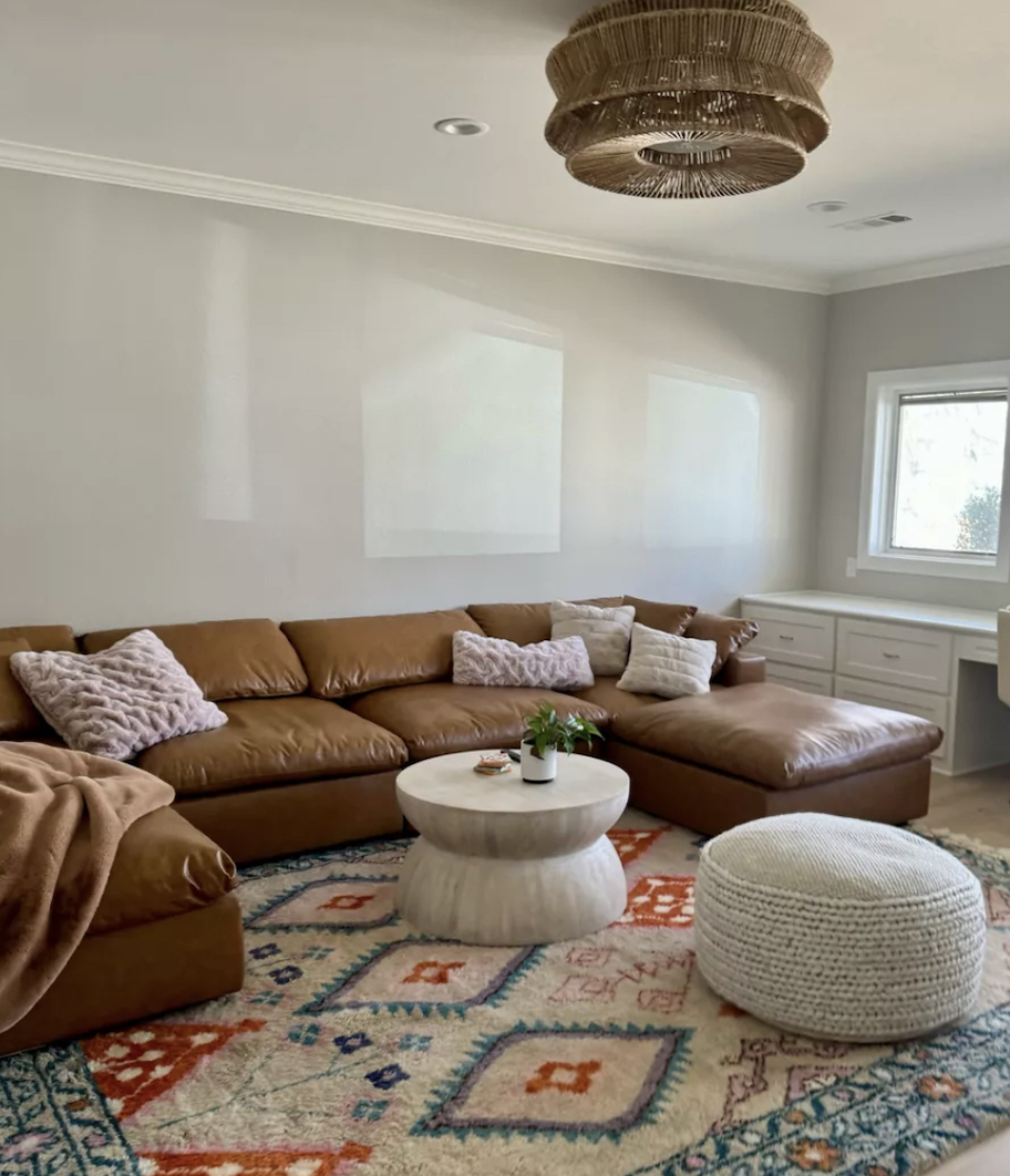 living room with leather sofa and boho decor