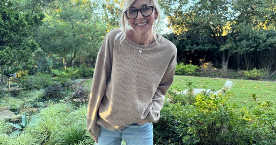 A woman wearing a PrettyGarden Pullover Sweatshirt in brown