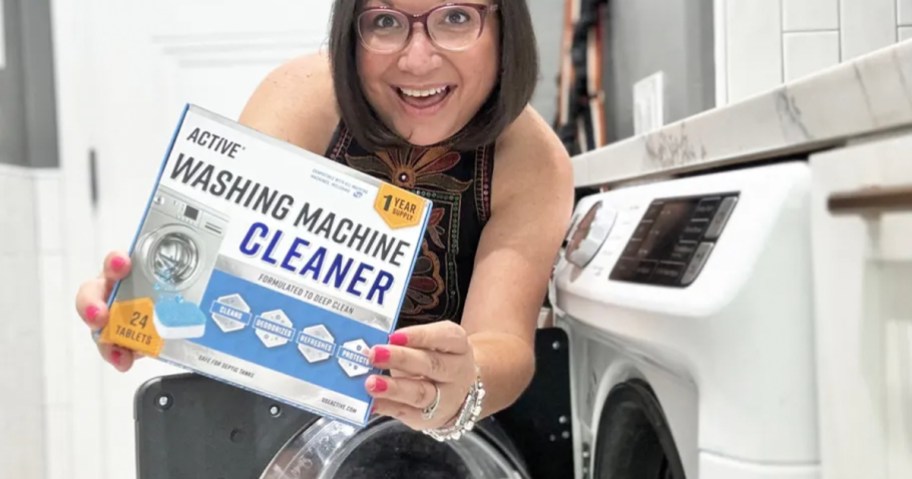 woman holding washing machine cleaner box near washer