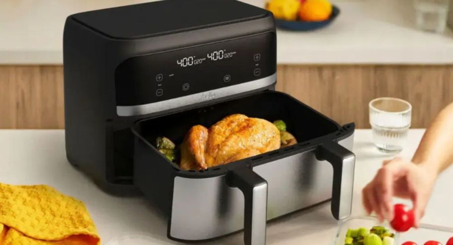 Dual basket airfryer with chicken inside of it