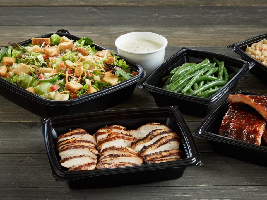 takeout food in black trays