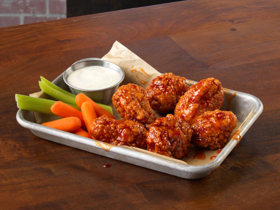 wings, vegetables, and ip on a silver tray