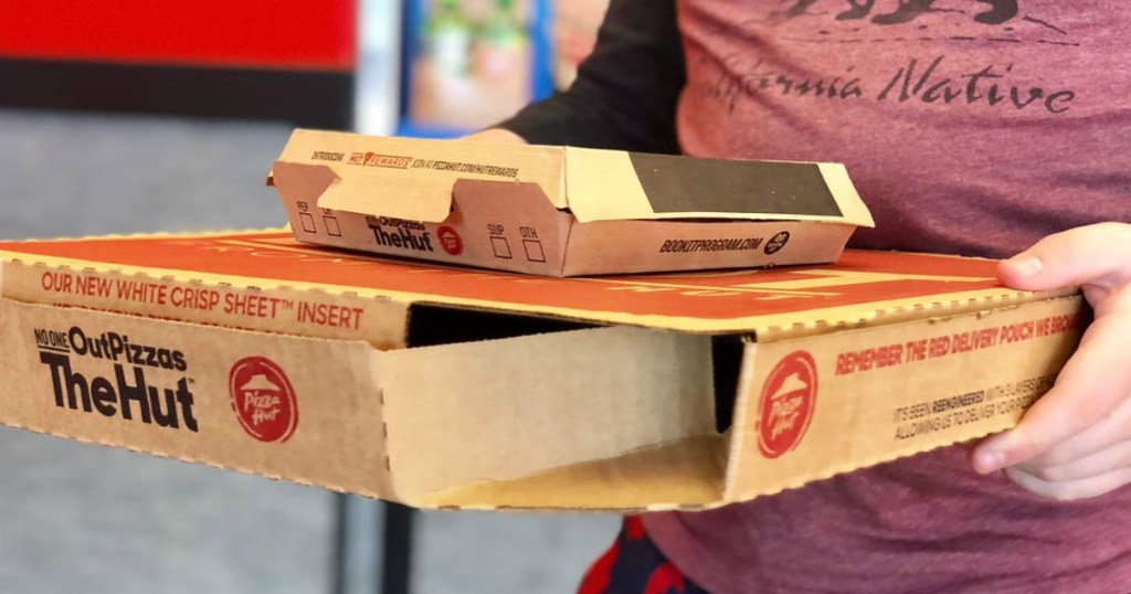 boy carrying Pizza hut boxes