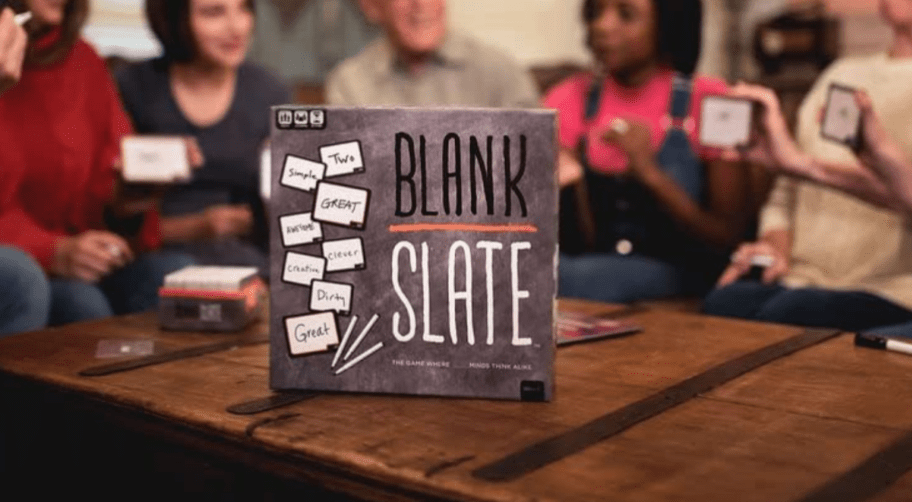 A family playing "Blank Slate" board game around a coffee table