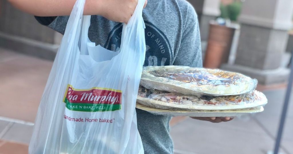 boy holding a Papa Murphy's <a href='https://tootightdu.com/product/premium-wig-storage-bag-pillowcases' target='_blank' rel='follow'>bag</a> and pizzas” width=”1024″ height=”538″></p>
<p class=