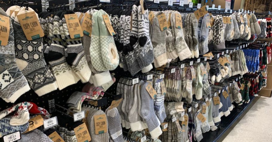 A wall of Cozy Cabin Socks and Slippers