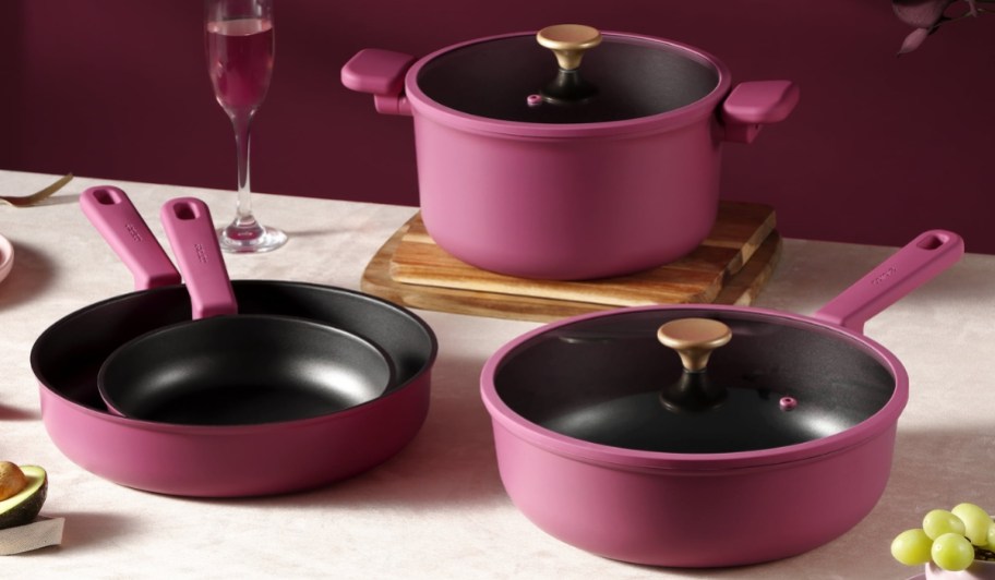 carote cookware pots and pans in pink on kitchen counter